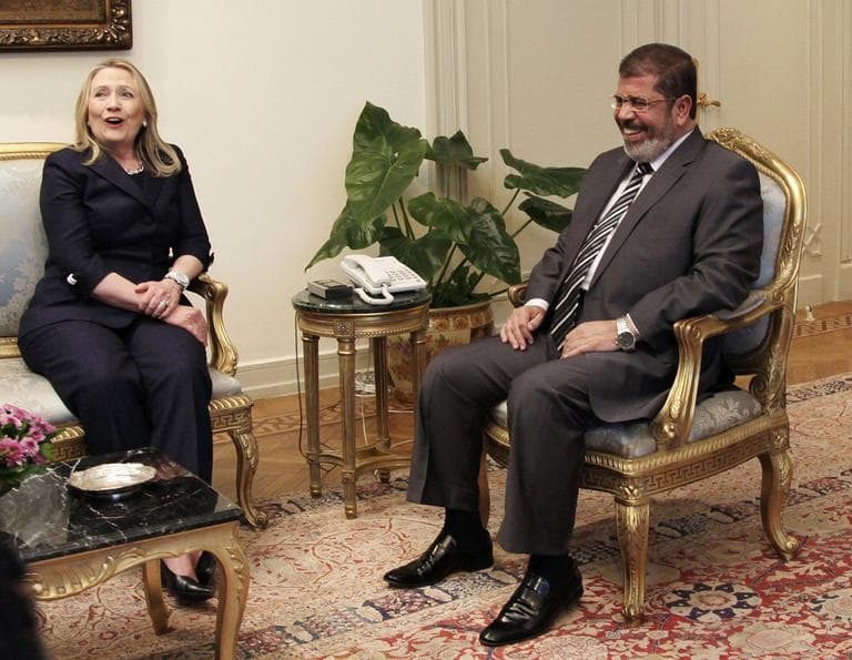 U.S. Secretary of State Hillary Clinton, left, and Egyptian President Mohammed Morsi laugh during a photo opportunity at their meeting at the Presidential palace in Cairo, Egypt, Saturday, July 14, 2012. (Maya Alleruzzo/AP)