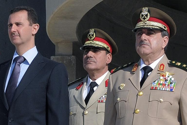 In this Thursday Oct. 6, 2011 photo released by the Syrian official news agency SANA, Syrian President Bashar Assad, left, stands next to Syrian Defense Minister Gen. Dawoud Rajha, right, during a ceremony to mark the 38th anniversary of the October 1973 Arab-Israeli war, in Damascus, Syria. Syria's state-run TV says the country's defense minister has been killed in a suicide blast in the capital. Wednesday's attack struck the National Security building in Damascus during a meeting of Cabinet ministers and senior security officials. (AP)