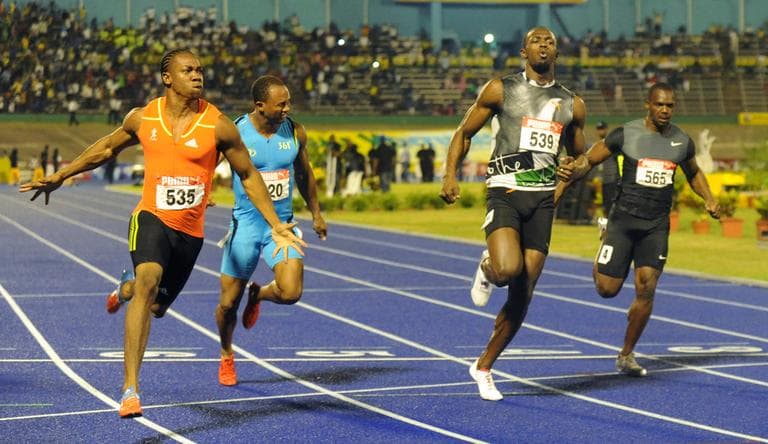 World champion Yohan Blake, left, celebrates after crossing the finish line ahead of current world-record holder Usain Bolt, second from right, Nesta Carter, right, and Michael Frater to win the 100m final at Jamaica's Olympic trials in Kingston, Jamaica. (AP)