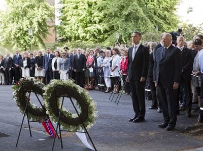 Norwegian Prime Minister Jens Stoltenberg (left) and King Harald attend a memorial ceremony near a government building damaged by a bomb attack in Oslo, Norway, Sunday. (AP)