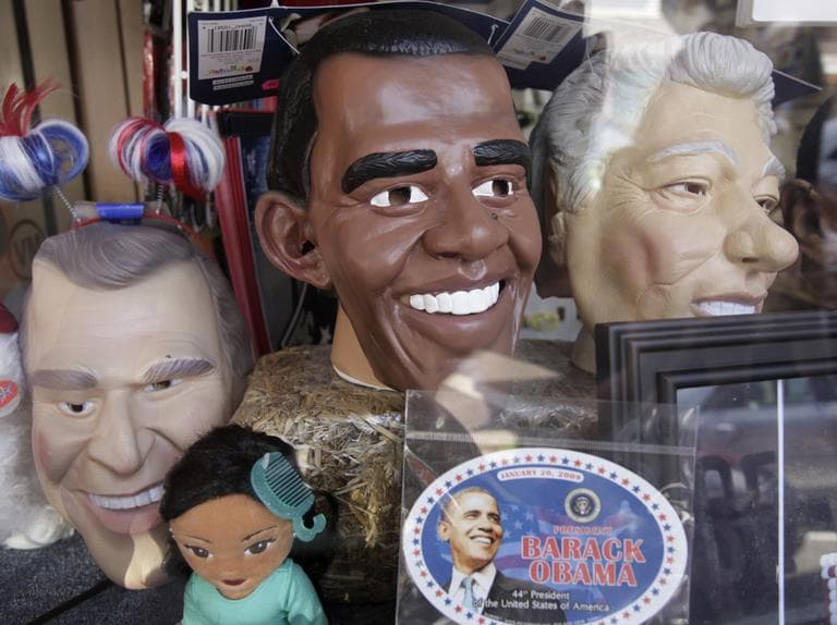 Life-sized masks meant to resemble U.S. presidents, from the left, George W. Bush, Barack Obama, and Bill Clinton, appear in a store-front window, in the downtown section of Oak Bluffs, Mass. (AP)