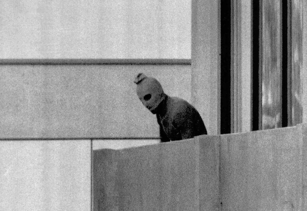 A Sept. 5, 1972 file photo shows a member of the Palestinian terrorist group who seized members of the Israeli Olympic team at their quarters at the Munich Olympic Village as the person appears with a hood over his face on the balcony of the village building where the hostages were held. (AP)