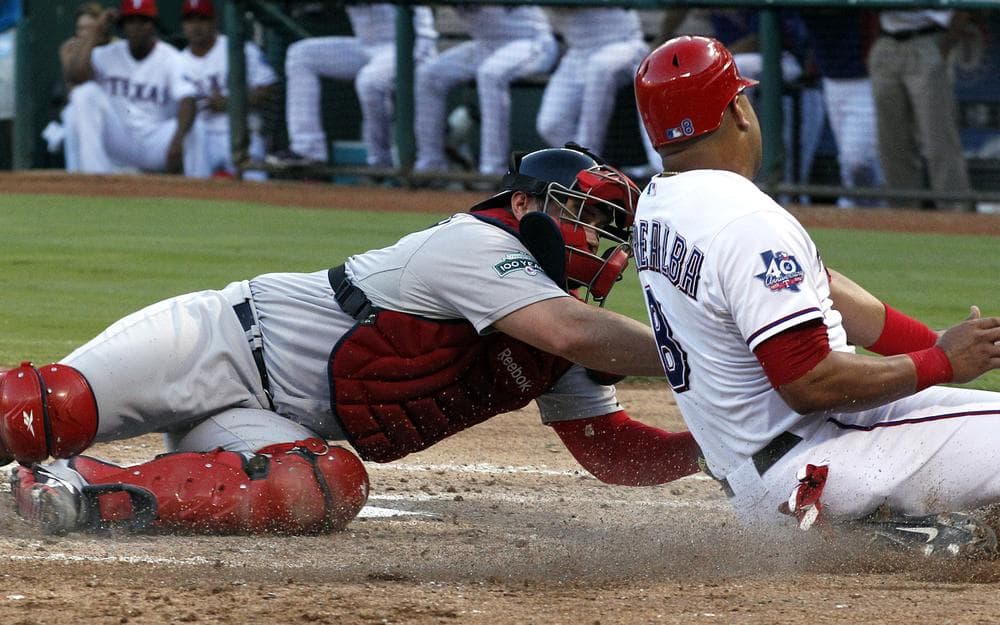 Rangers' Yorvit Torrealba is tagged out sliding into home by Red Sox catcher Kelly Shoppach during the third inning in Arlington, Texas. (AP)
