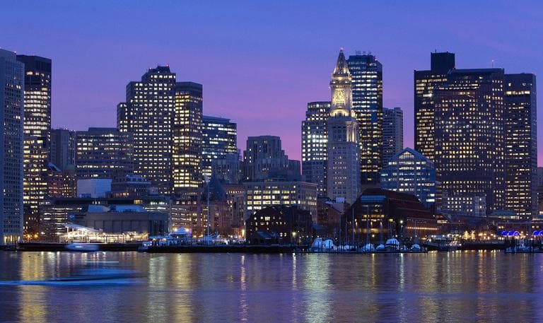 The city skyline is seen at dusk on the Boston Harbor. (AP)