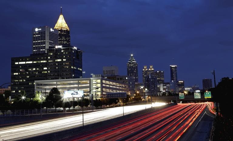 Traffic moves along Interstate 75 against the downtown skyline in Atlanta. (AP)