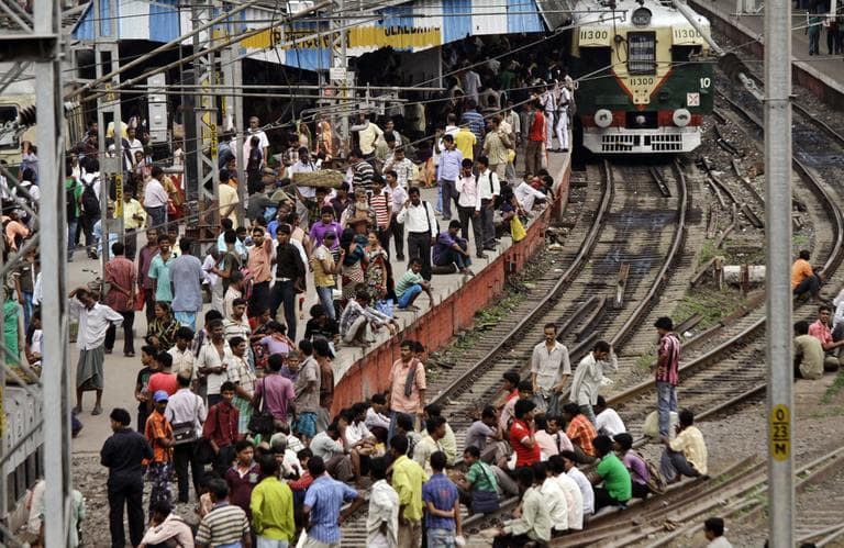 Indian stranded passengers wait for the train services to resume following a power outage at Sealdah station in Kolkata, India, Tuesday. (AP)