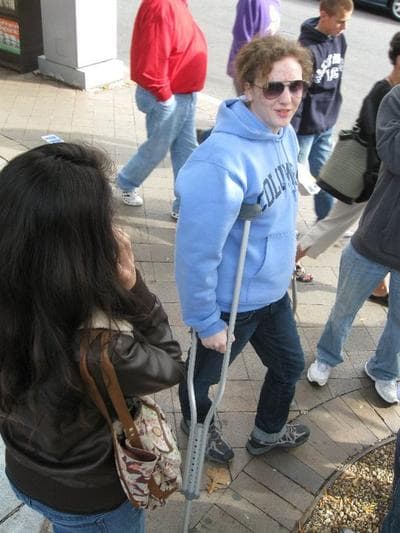 Annie donning a pair of crutches to get around at the Jon Stewart march on the Natl Mall October 2010 . (Courtesy: Annie Ropeik)