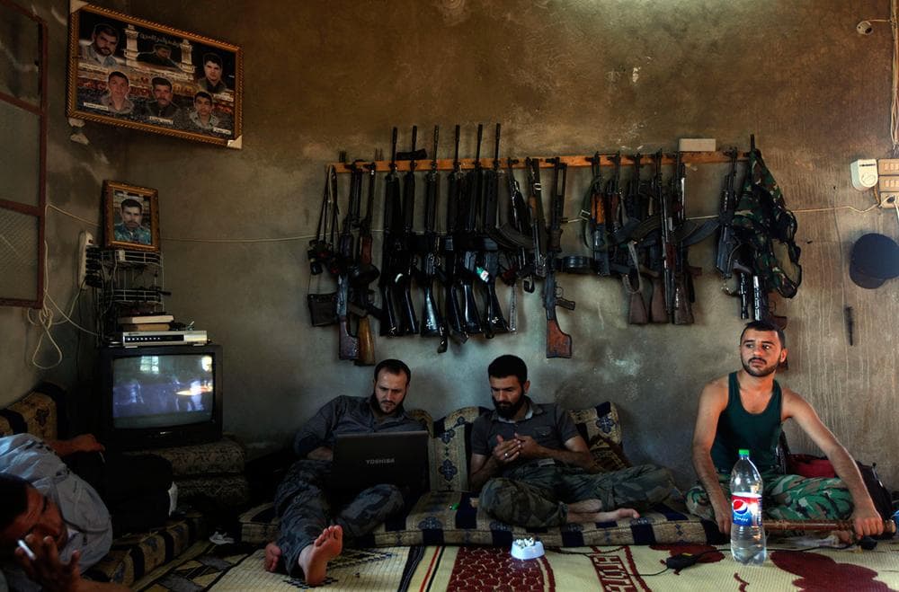 Free Syrian Army fighters sit in a house on the outskirts of Aleppo