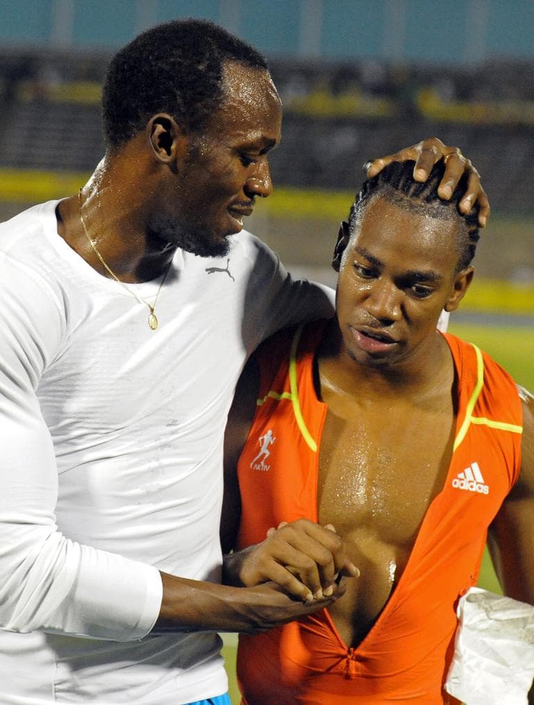 World champion Yohan Blake, right, is congratulated by world-record holder Usain Bolt after Blake defeated Bolt in the 100m final at Jamaica's Olympic trials in Kingston, Jamaica in June. (AP)