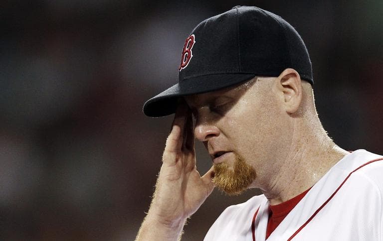 Red Sox starting pitcher Aaron Cook wipes his face while leaving the game after giving up five runs to the Detroit Tigers during the fifth inning. (AP Photo/Winslow Townson)