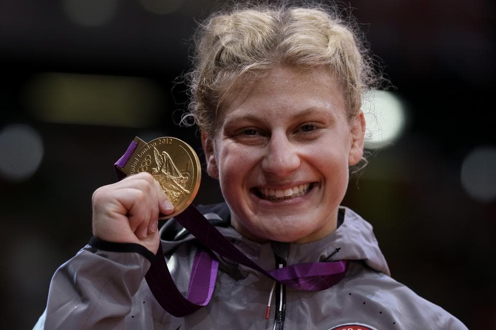 Kayla Harrison flashes her gold medal...and her gold medal smile.  (AP) 