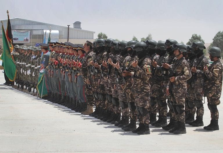 Afghan security forces stand in formation during the third phase of transfer of authority from NATO troops to Afghan security forces in Kandahar south of Kabul, Afghanistan on Wednesday, July 18, 2012.  (AP Photo/Allauddin Khan)