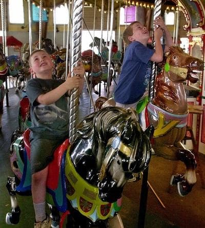 Two boys ride Hull's Paragon Carousel in 2001. (AP)