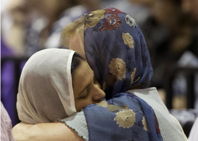 Mourners console one another at the funeral and memorial service for the six victims of the Sikh temple of Wisconsin mass shooting in Oak Creek, Wis., Friday, Aug 10, 2012. (AP)