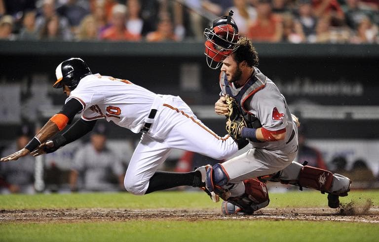 Baltimore Orioles&#039; Adam Jones, left, and Red Sox catcher Jarrod Saltalamacchia collide at the plate in the sixth inning of a baseball game on Wednesday. (AP Photo/Gail Burton)
