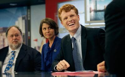 Joseph Kennedy III, right, laughs while listening to NECN host Jim Braude during a candidate's debate for the 4th Congressional District Thursday. With Kennedy are Herb Robinson and Rachel Brown. (AP)