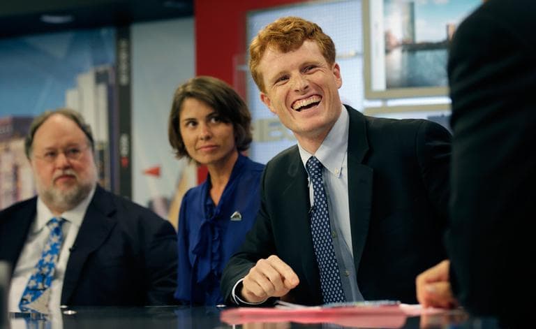 Joseph Kennedy III, right, laughs while listening to NECN host Jim Braude during a candidate&#039;s debate for the 4th Congressional District Thursday. With Kennedy are Herb Robinson and Rachel Brown. (AP)