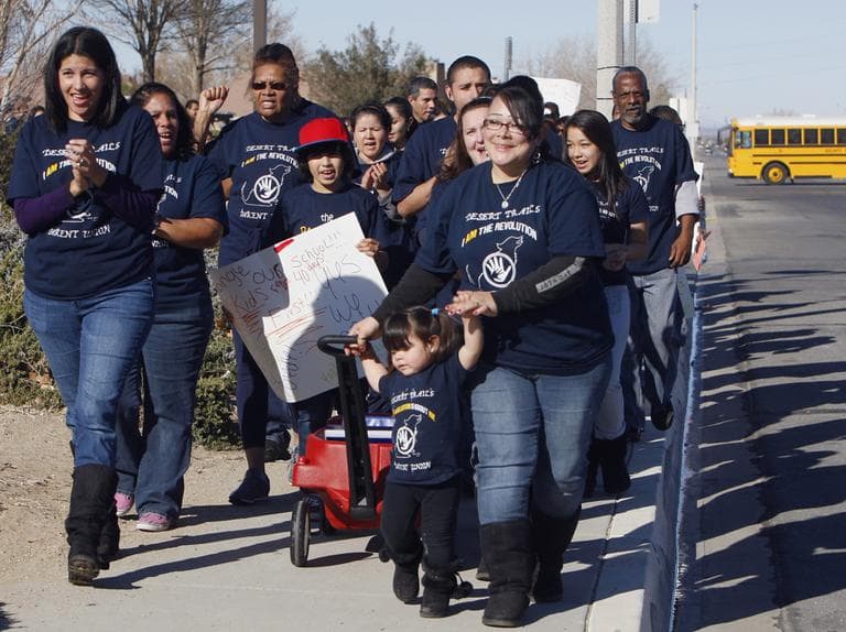 Desert Trails elementary school parents and guardians walk to file a petition calling for their school to be converted to a charter school in 2012 in the Mojave Desert town of Adelanto, Calif. (AP)