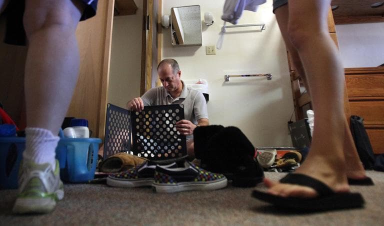 In this Aug. 16, 2010, file photo, Paul Kramer, of Chicago, puts together a shoe organizer as he helps his daughter Ariana move into her dorm room at the University of Iowa in Iowa City. (AP File)