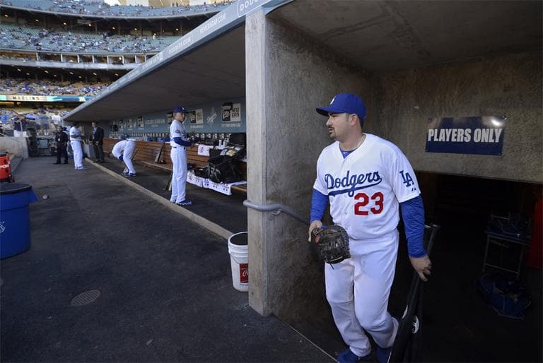 Dodgers first baseman Adrian Gonzalez walks into the dugout before a game against the Miami Marlins, Saturday. Gonzalez was acquired from the Boston Red Sox in a nine-player trade. (AP)