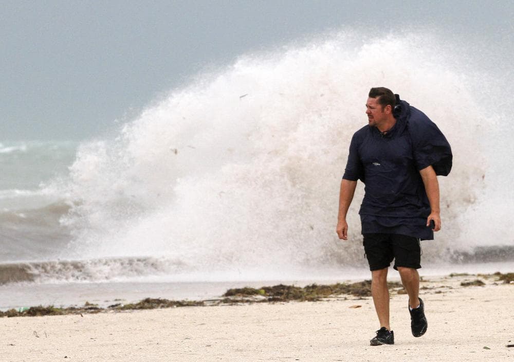 A man walks on the beach in Key West, Fla. as heavy winds hit the northern coast from Tropical Storm Isaac. (AP)
