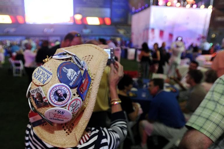Judy Griffin, of Georgia, takes photos while wearing a hat with Republican Party buttons during the 2012 Tampa Bay Host Committee’s welcoming event for the delegates of the Republican National Convention on Sunday, Aug. 26, 2012 at Tropicana Field in St. Petersburg, Fla. (AP)