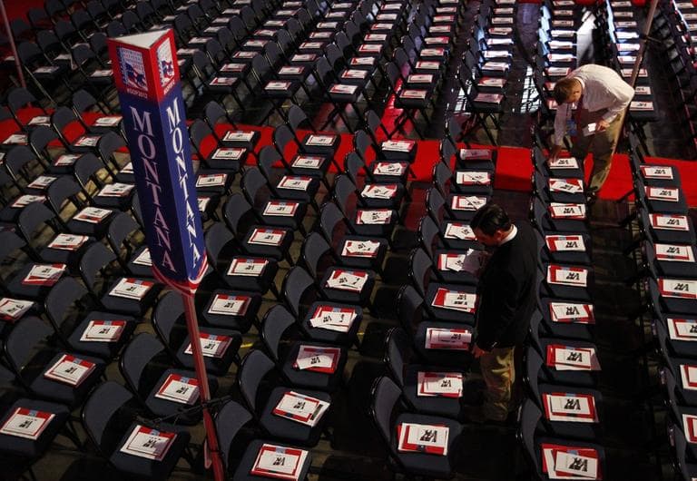 A volunteer places pamphlets on chairs in Montana's delegation seating area before the start of the Republican National Convention in Tampa, Fla., on Tuesday. (AP/Lynne Sladky)