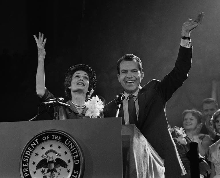 Mrs. Nixon glances up and Vice President Nixon waves to Republican convention from rostrum in Chicago on July 29, 1960. He came before convention to accept presidential nomination. (AP)