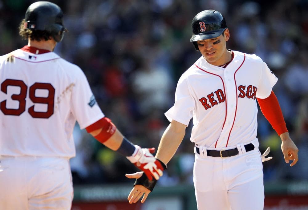 Jacoby Ellsbury, right, celebrates with Jarrod Saltalamacchia as he scores on a double hit by Cody Ross in the sixth inning Monday in Boston. The Red Sox won 5-1. (AP)