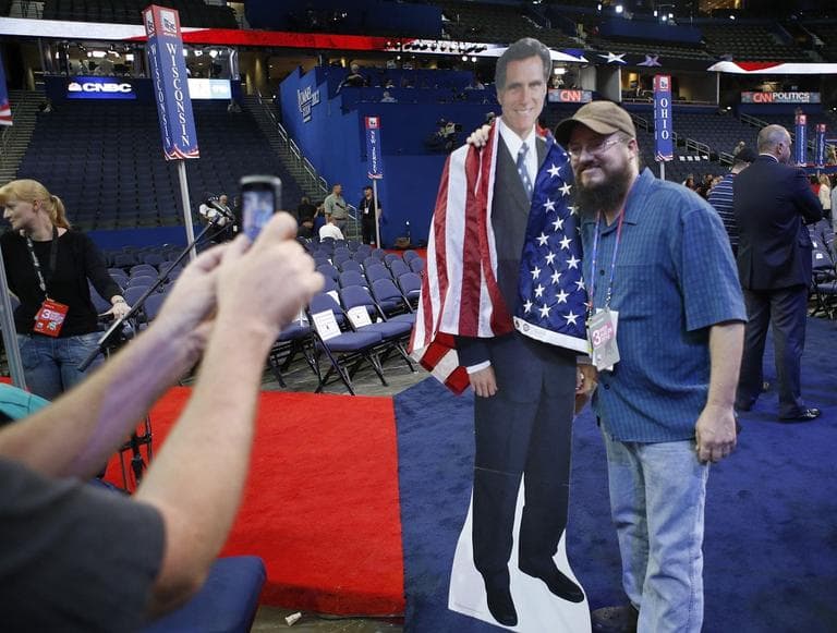 Travis Chapin from St. Petersburg, Fla., poses for a picture with a life-size picture figure of Mitt Romney on the floor at the Republican National Convention in Tampa, Fla., on Wednesday. (AP/Jae C. Hong)