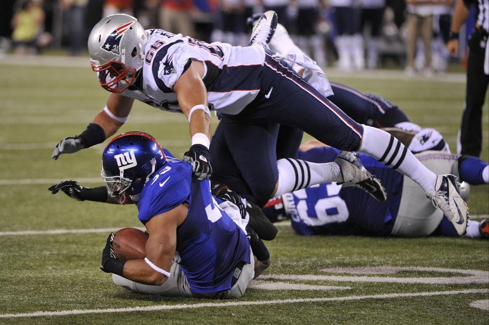 New England Patriots defensive end Jake Bequette tackles New York Giants defensive back Dante Hughes during the second half a preseason game last night. The Giants won the game 6-3. (AP Photo)