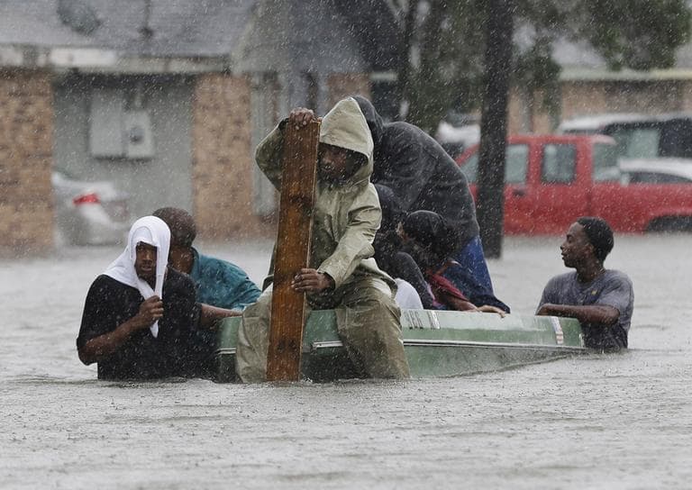 Residents evacuate their flooded neighborhood in LaPlace, La. on Thursday, a day after Hurricane Isaac hit the area. (AP)