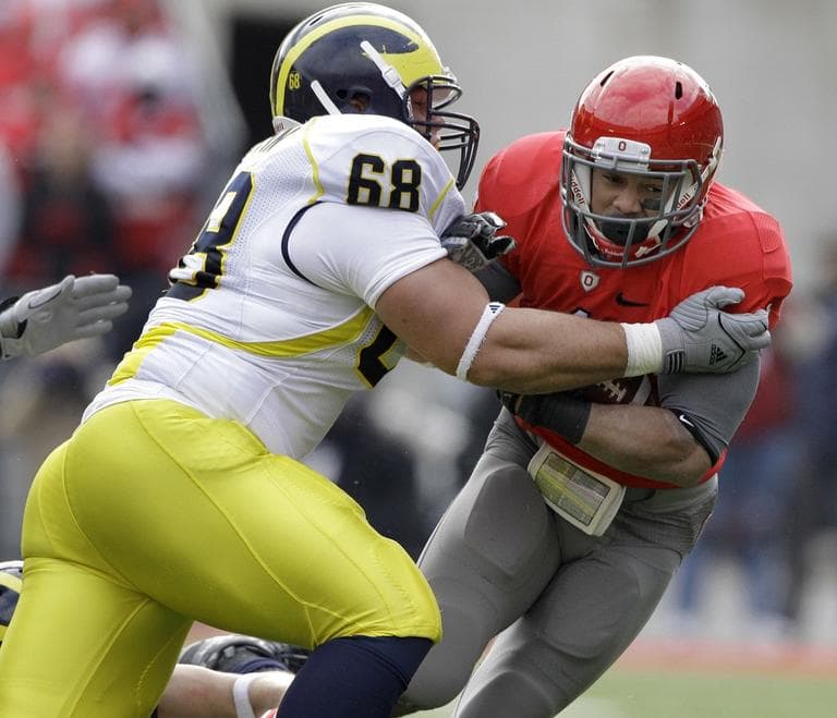 Ohio State  running back Dan Herron (1) is tackled by University of Michigan defensive tackle Mike Martin (68) in 2010. (AP/Amy Sancetta)