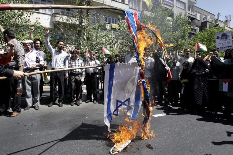 Iranian demonstrators burn an Israeli and British flag during a an annual pro-Palestinian rally marking Quds (Jerusalem) Day, on the last Friday of the holy month of Ramadan, at the Enqelab-e-Eslami (Islamic Revolution) St. in Tehran, Iran, Friday, Aug. 17, 2012. (AP)