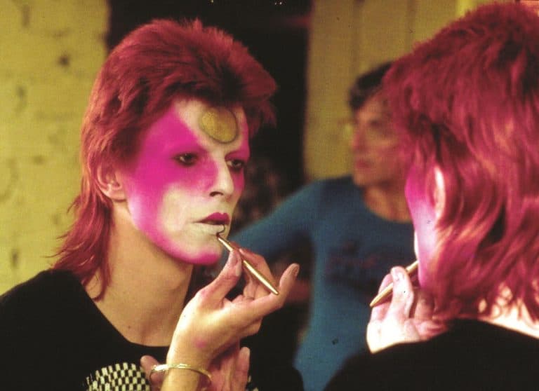 David Bowie applies his makeup. (R. Bamber/Rex Features/Courtesy Everett Collection)