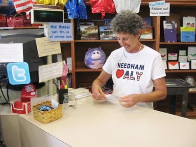 Toby Sandler, an employee at Taylor's Stationery, wearing one of the store's t-shirts supporting Raisman (Lynn Jolicoeur for WBUR)