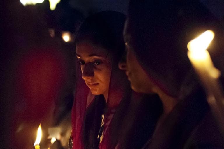 A woman holds a candle at a vigil held by the New England Sikh Society in Milford on Monday (Josh Berlinger for WBUR)