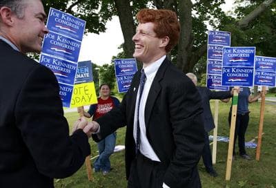Joseph Kennedy III visits with voters outside a polling station at a school in Needham on Thursday. (AP)