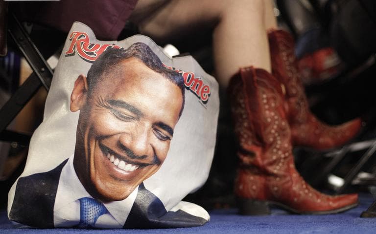 Colorado delegate Tracy Ducharme wears cowboy boots as she sit next to her bag showing President Barack Obama during the Democratic National Convention. (AP)