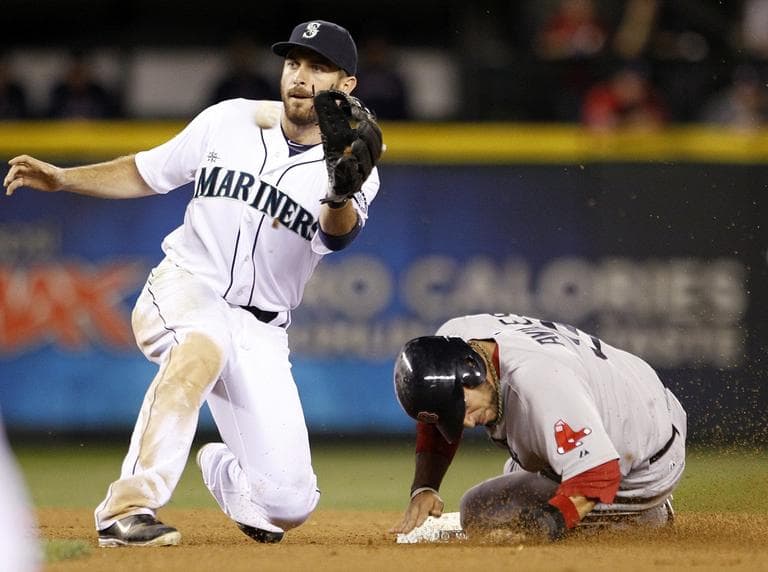 Mariners second baseman Dustin Ackley, left, waits for the ball as Mike Aviles steals second base in the seventh inning of a baseball game Wednesday, Sept. 5, 2012, in Seattle. (AP/Elaine Thompson)