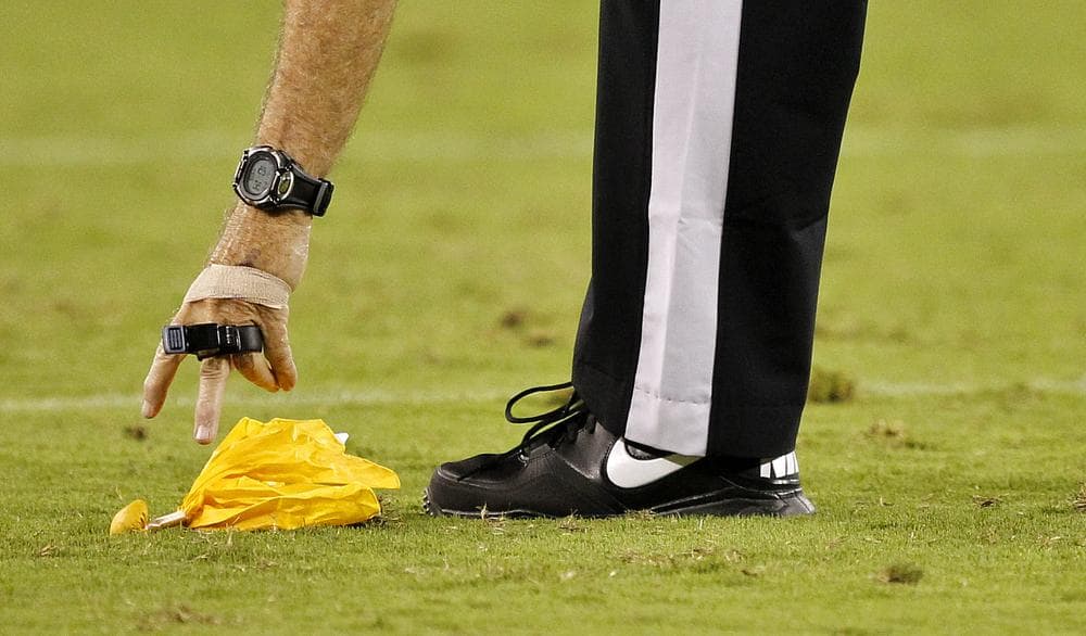 Yellow flags get a lot of attention, but they're a small part of the job description for NFL officials. (AP)