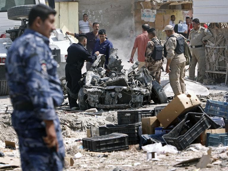 Security forces inspect the scene of a car bomb attack in Basra, 340 miles southeast of Baghdad, Iraq, Sunday, Sept. 9, 2012. (AP)