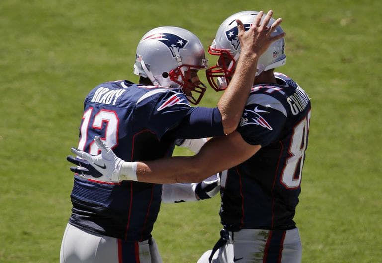 New England Patriots quarterback Tom Brady (12) celebrates with tight end Rob Gronkowski (87) after throwing a two-yard touchdown pass to Gronkowski in the second quarter against the Tennessee Titans on Sunday, Sept. 9, 2012. (AP)