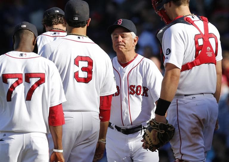 Boston Red Sox manager Bobby Valentine, second from right, arrives at the mound to take out starting pitcher Clay Buchholz during the ninth inning Sunday. (AP)