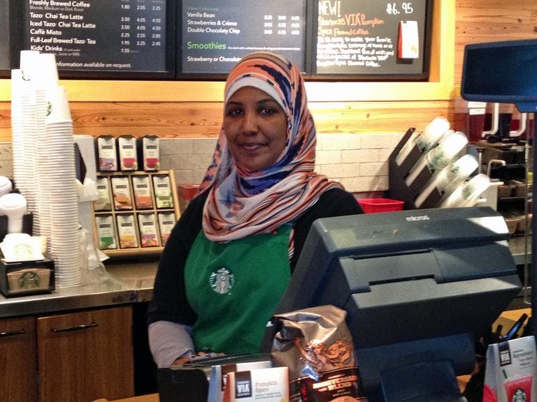 Barwaqo Mohamed works at the Starbucks in Logan Airport in Boston, Mass. (Chris Ballman/Here & Now)
