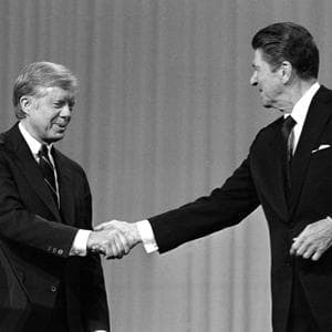 Jimmy Carter and Ronald Reagan shake hands after debating in the Cleveland Music Hall on Oct. 28, 1980. (AP File Photo)