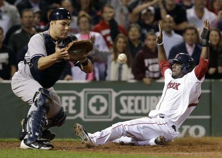 Red Sox's Pedro Ciriaco slides in to score the winning run on a single hit by Jacoby Ellsbury as New York Yankees catcher Russell Martin, left, waits for the late throw on Tuesday. (AP/Elise Amendola)