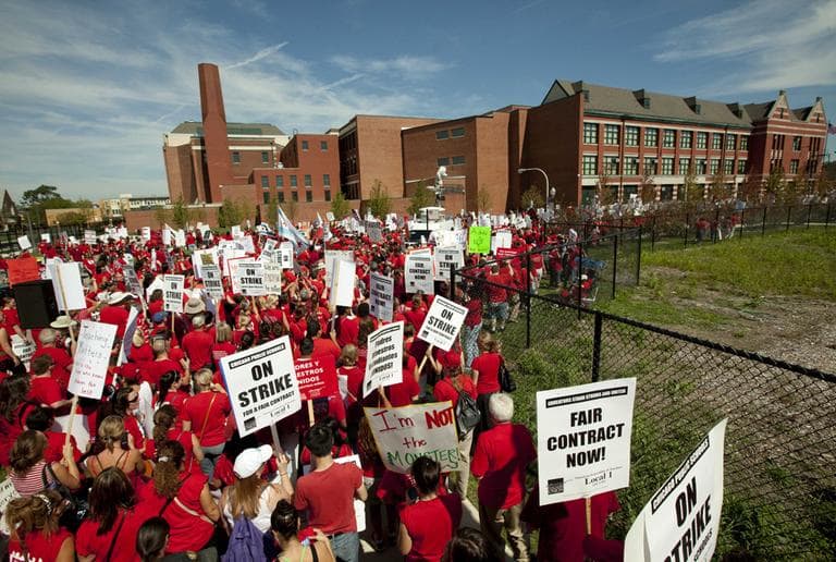 A large group of public school teachers marches past John Marshall Metropolitan High School on Wednesday in West Chicago. (AP)