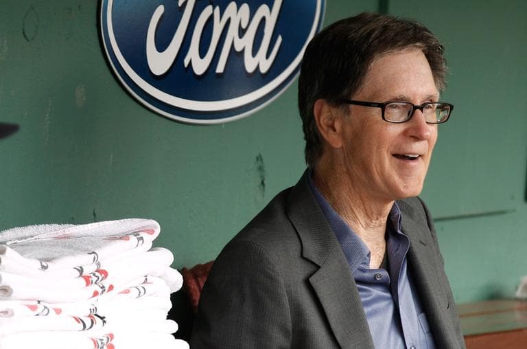 Boston Red Sox owner John Henry in a Fenway Park dugout, in this July 20 file photo (AP)