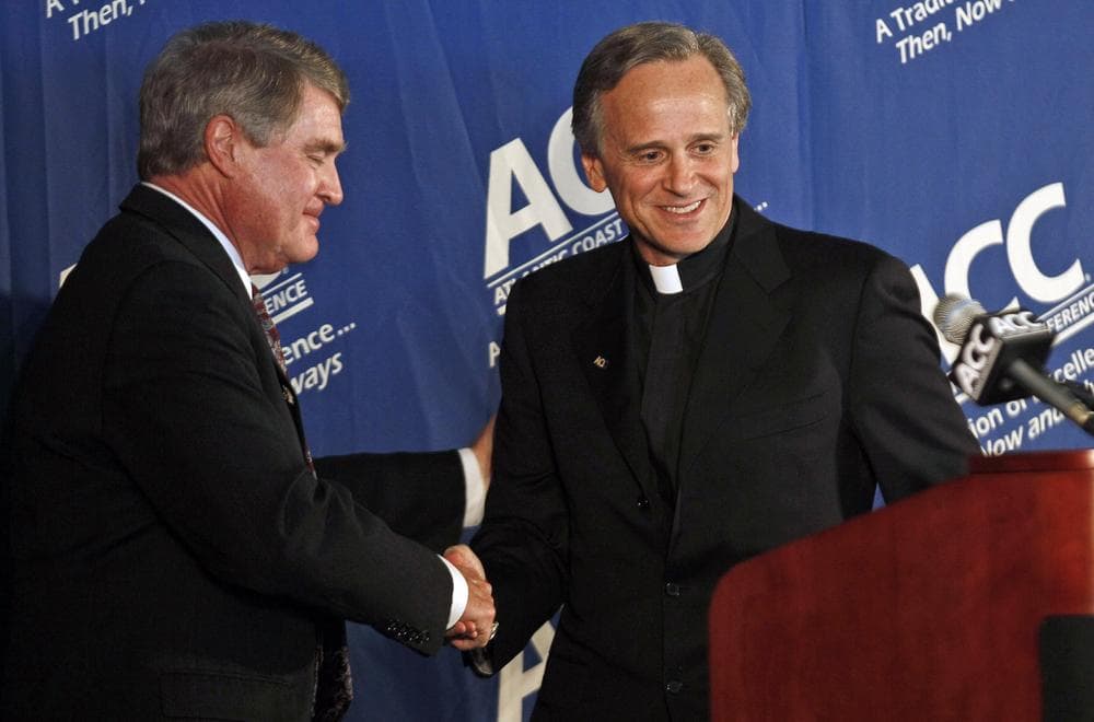 ACC Commissioner John Swofford shakes the hand of Notre Dame president Rev. John I. Jenkins after Notre Dame announced it would join the ACC. The Fighting Irish will maintain an independent football team. (AP)
